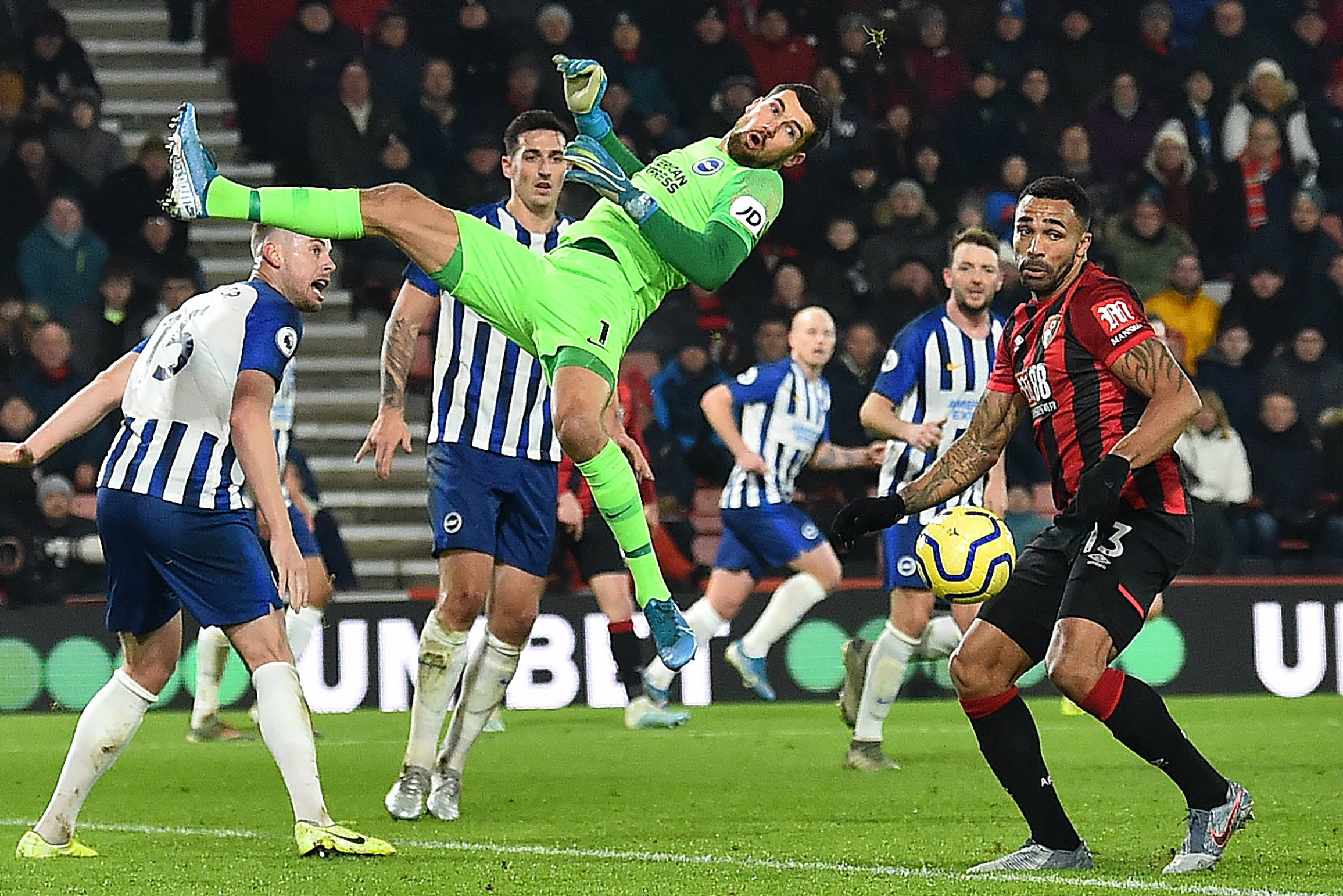 Mat Ryan throwns himself at the ball against Bournemouth