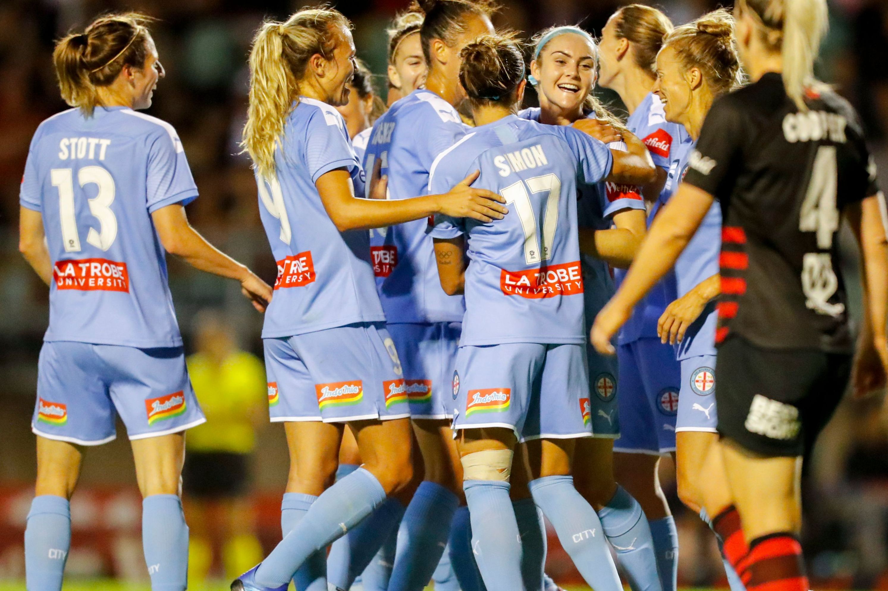 City players embrace Ellie Carpenter after one of her two goals