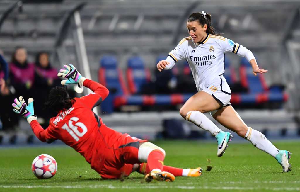 Chiamaka Nnadozie of Paris FC dives at the feet of Hayley Raso of Real Madrid during the UEFA Women's Champions League group stage match between Paris FC and Real Madrid CF at Stade Charlety on December 14, 2023 in Paris, France. (Photo by Franco Arland/Getty Images)