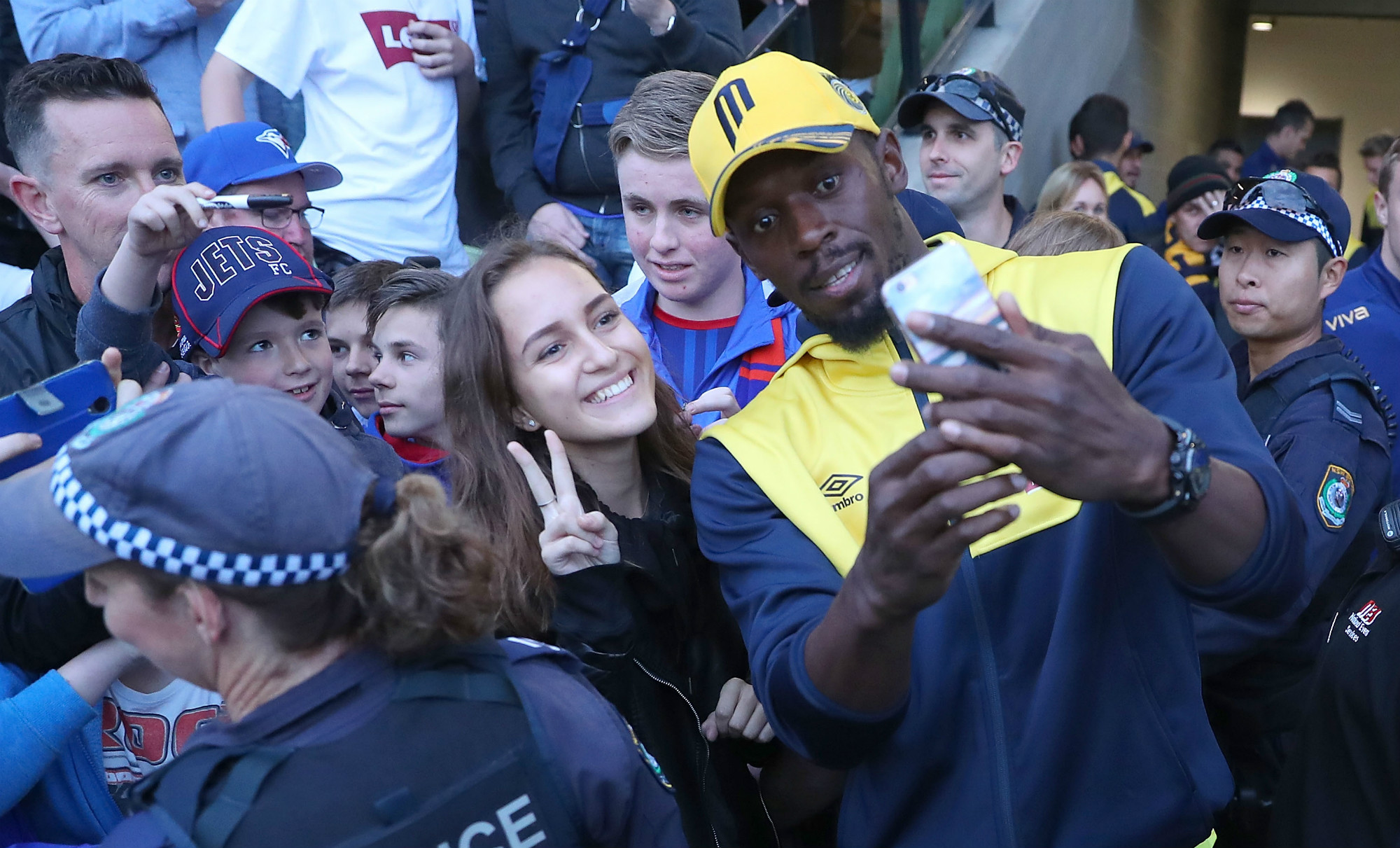 Bolt snaps selfies with fans from the sidelines in Maitland
