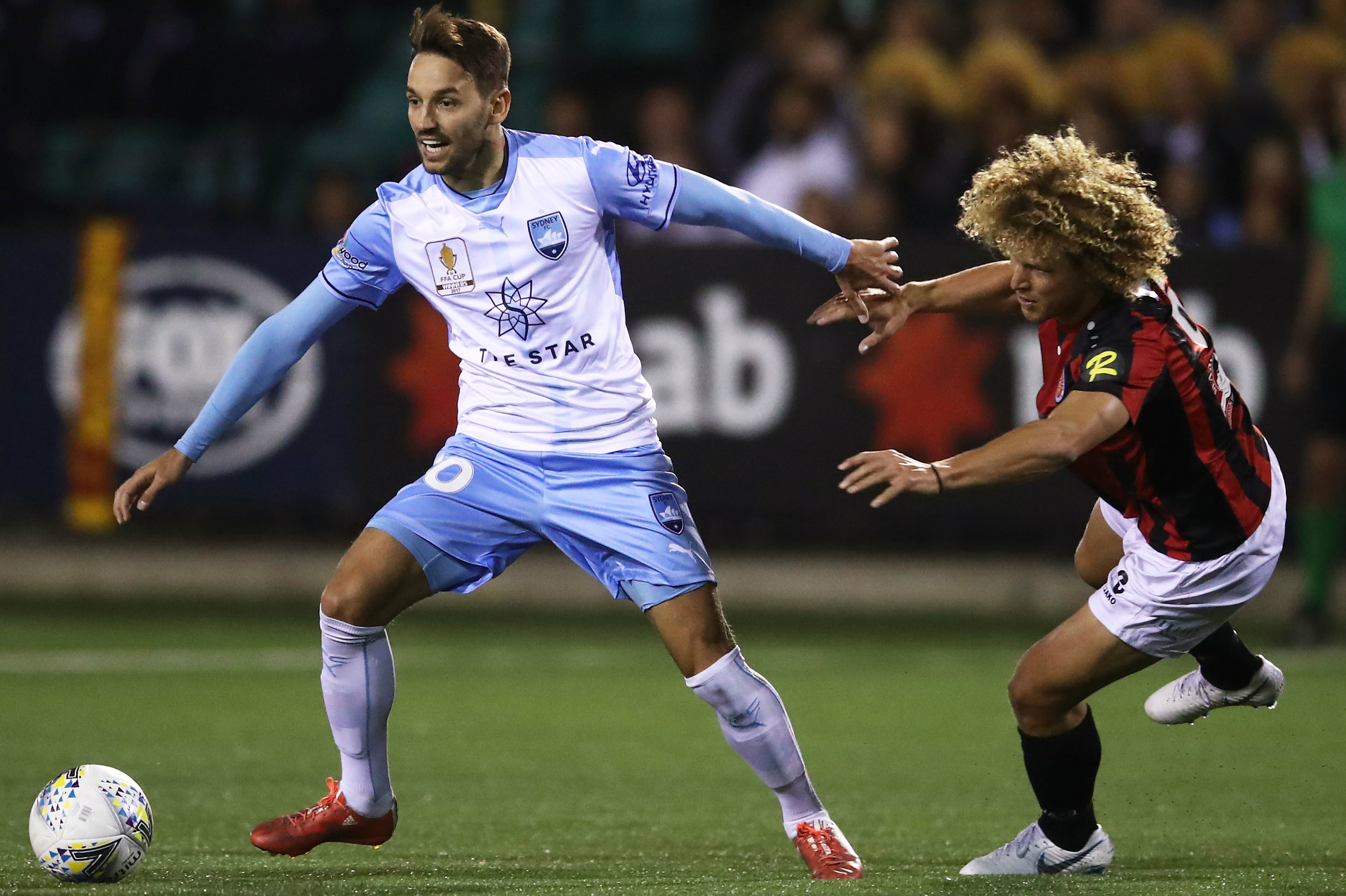 Sydney FC's Milos Ninkovic takes on Rockdale's Blake Ricciuto.