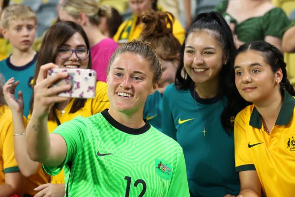 Teagan Micah of Australia takes selfies with fans after her team's victory the International Women's match between the Australia Matildas and the New Zealand Football Ferns at Queensland Country Bank Stadium on April 08, 2022 in Townsville, Australia. (Photo by Albert Perez/Getty Images)